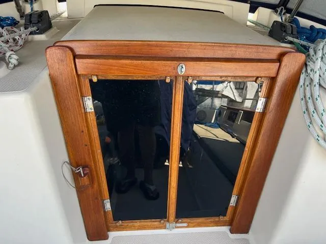  Yacht Photos Pics Wooden hatch door on 1999 Island Packet 380 sailboat, featuring glass panels and nautical ropes.
