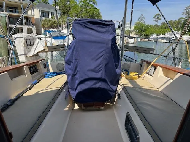  Yacht Photos Pics 1999 Island Packet 380 sailboat cockpit with covered helm, docked in a marina.