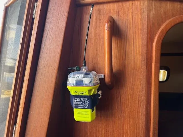  Yacht Photos Pics EPIRB device mounted on wooden interior of 1999 Island Packet 380 sailboat.