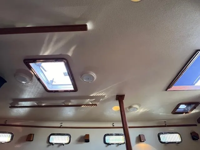  Yacht Photos Pics Interior ceiling of a 1999 Island Packet 380 sailboat with skylights and lighting fixtures.