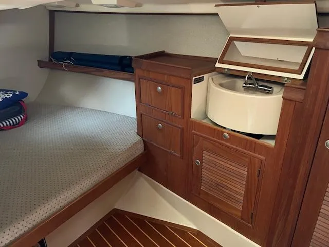  Yacht Photos Pics Island Packet 380 sailboat interior with wooden cabinetry and compact sink, 1999 model.