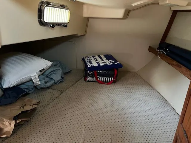  Yacht Photos Pics Cozy cabin interior of 1999 Island Packet 380 sailboat with bedding and storage.