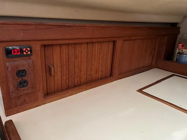  Yacht Photos Pics 1999 Island Packet 380 interior with wooden cabinetry and electrical outlets.