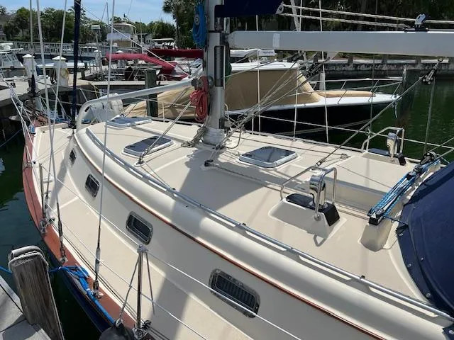  Yacht Photos Pics 1999 Island Packet 380 sailboat docked at marina, showcasing deck and rigging.
