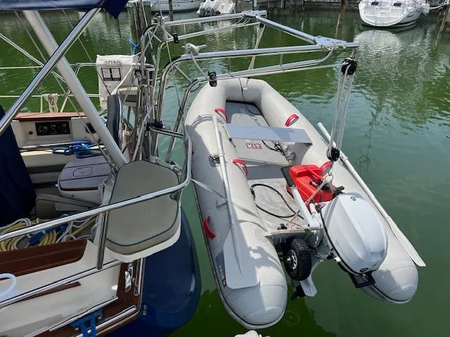  Yacht Photos Pics Inflatable dinghy attached to a 1999 Island Packet 380 sailboat at a marina.