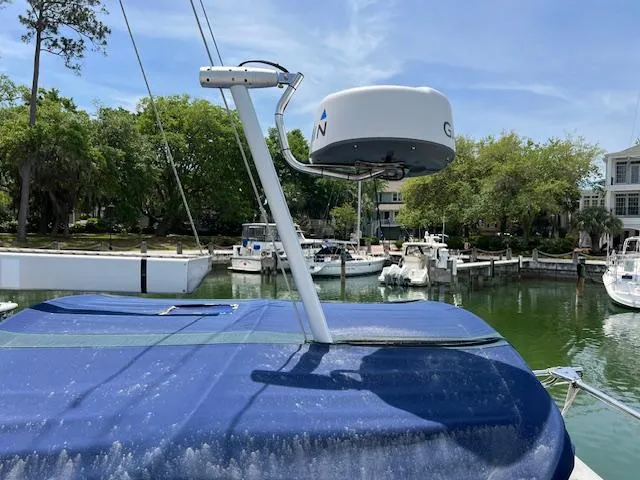  Yacht Photos Pics 1999 Island Packet 380 sailboat with radar, docked in a serene marina setting.