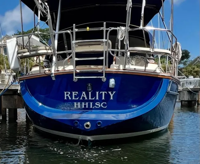 Yacht Photos Pics 1999 Island Packet 380 sailboat named "Reality" docked in a marina.