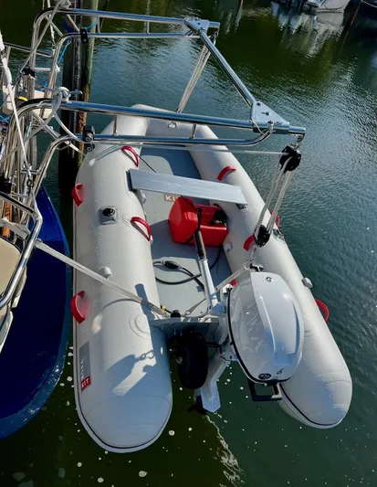  Yacht Photos Pics Inflatable dinghy with motor, suspended on Island Packet 380 sailboat, 1999 model, docked in marina.