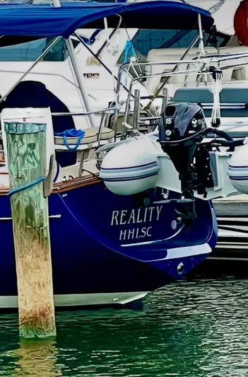  Yacht Photos Pics Island Packet 380 sailboat, 1999 model, docked with dinghy and outboard motor.