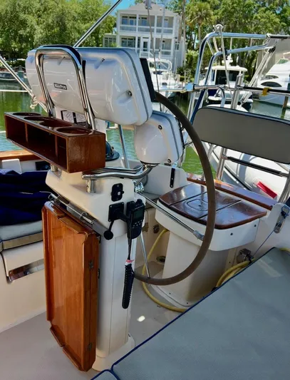  Yacht Photos Pics 1999 Island Packet 380 sailboat cockpit with steering wheel and navigation equipment.