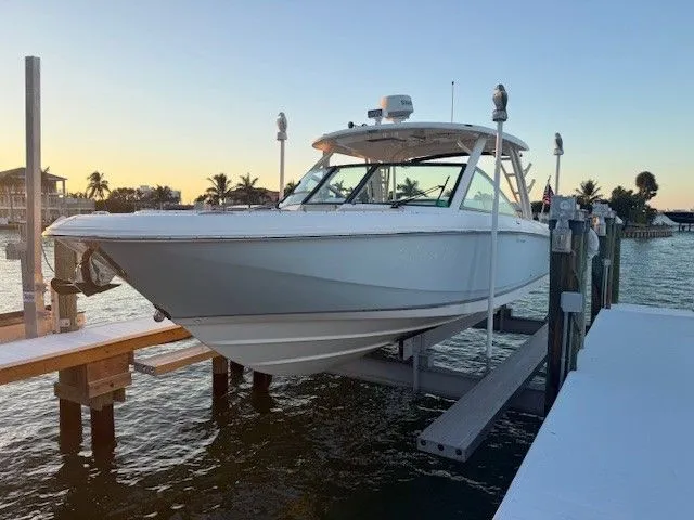  Yacht Photos Pics 2017 Boston Whaler 320 Vantage on boat lift at sunset.