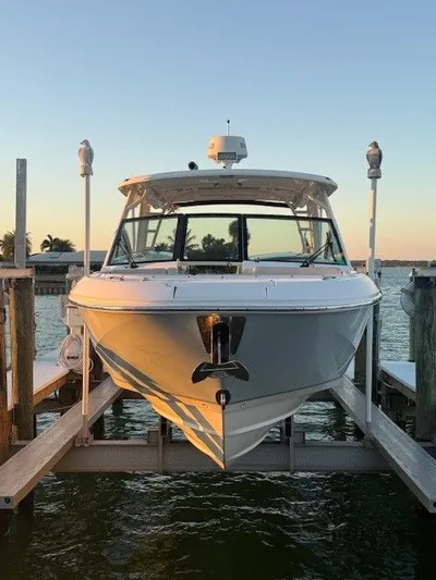  Yacht Photos Pics 2017 Boston Whaler 320 Vantage on a boat lift at sunset.