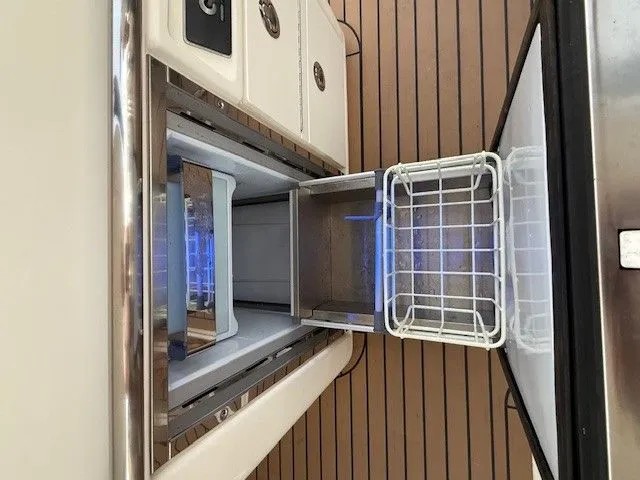  Yacht Photos Pics Boston Whaler 320 Vantage 2017 kitchen area with open refrigerator.