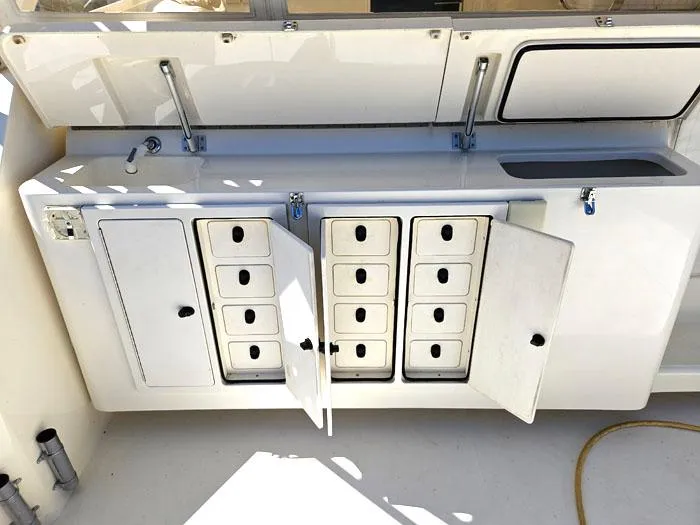  Yacht Photos Pics 2001 Carolina Classic Express 35 boat storage compartments with open doors and multiple drawers.