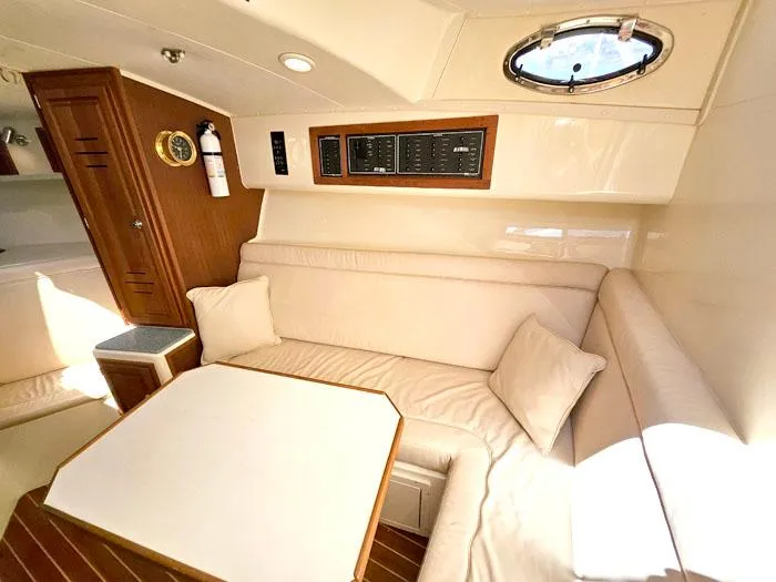  Yacht Photos Pics Interior of 2001 Carolina Classic Express 35 with beige seating and wooden accents.
