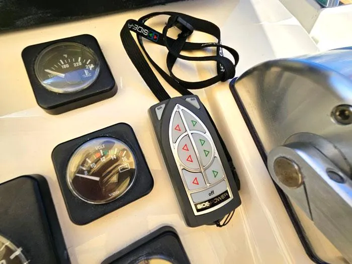  Yacht Photos Pics Control panel of a 2001 Carolina Classic Express 35 boat with gauges and remote.