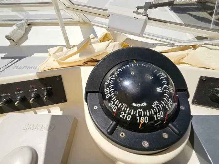  Yacht Photos Pics Compass and controls on a 2001 Carolina Classic Express 35 boat dashboard.