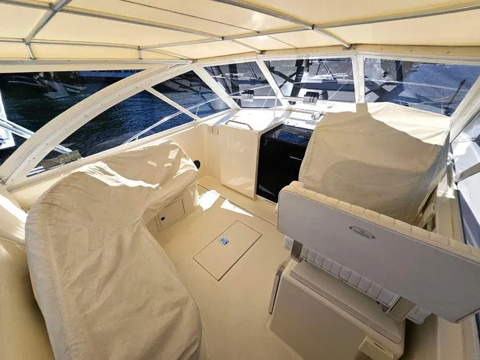  Yacht Photos Pics 2001 Carolina Classic Express 35 boat interior with covered seating and helm.