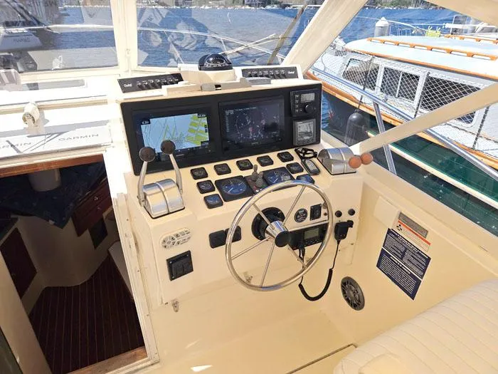  Yacht Photos Pics Helm of 2001 Carolina Classic Express 35 boat with navigation equipment and controls.