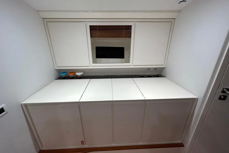  Yacht Photos Pics Modern interior of 2022 Itama 45s yacht with sleek cabinetry and minimalist design.