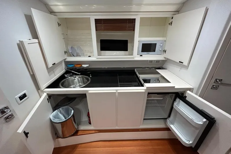 Yacht Photos Pics Modern kitchen in a 2022 Itama 45s yacht, featuring sleek cabinetry and appliances.