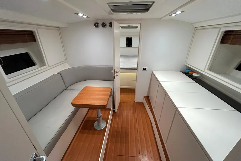  Yacht Photos Pics Luxurious interior of 2022 Itama 45s yacht with modern seating and wooden flooring.