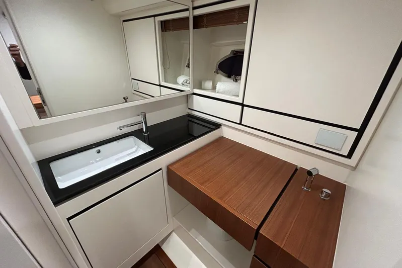  Yacht Photos Pics Luxurious bathroom interior of 2022 Itama 45s yacht with modern sink and wooden accents.