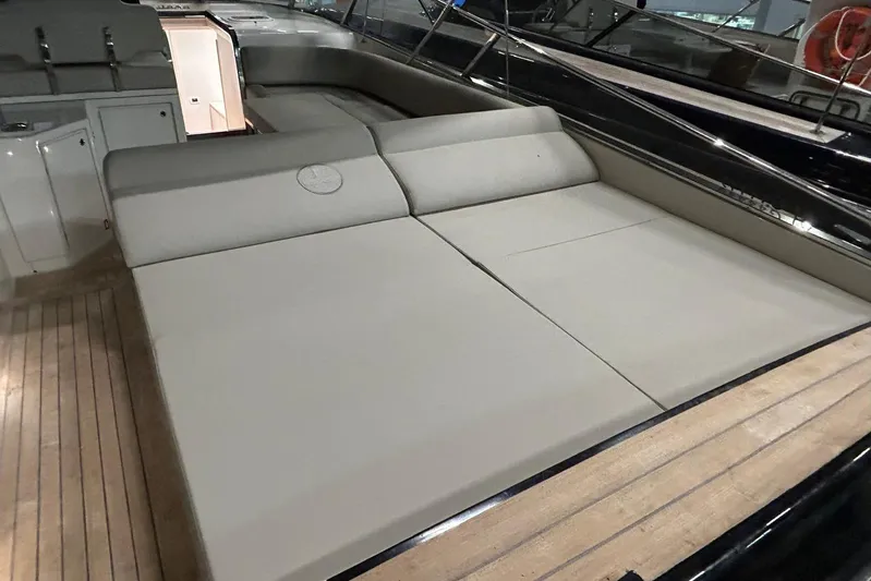  Yacht Photos Pics Luxury sunbed on 2022 Itama 45s yacht with sleek design and wooden deck.