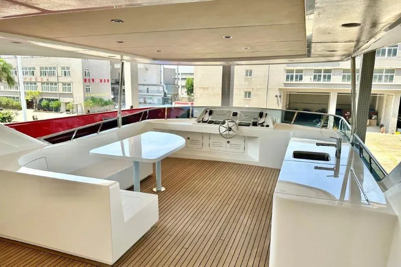  Yacht Photos Pics Luxurious Lanzarote 7702 yacht deck with seating, table, and helm, 2025 model.