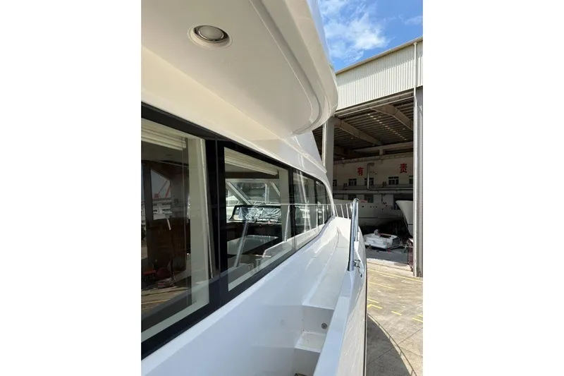  Yacht Photos Pics 2025 Lanzarote 7702 yacht exterior, showcasing sleek design and modern architecture in a shipyard.