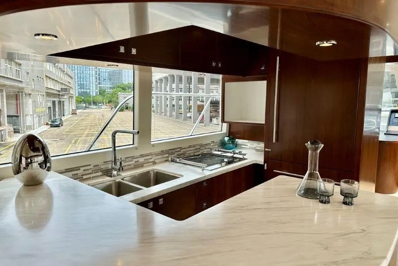  Yacht Photos Pics Luxurious Lanzarote 7702 yacht kitchen with modern design, marble countertops, and scenic window view.