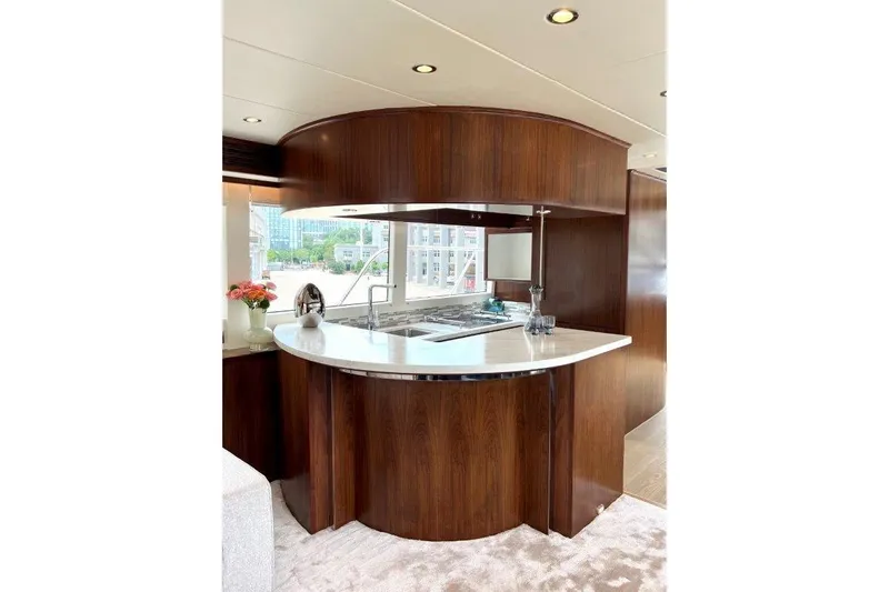  Yacht Photos Pics Luxurious kitchen interior of 2025 Lanzarote 7702 yacht with elegant wood finish.