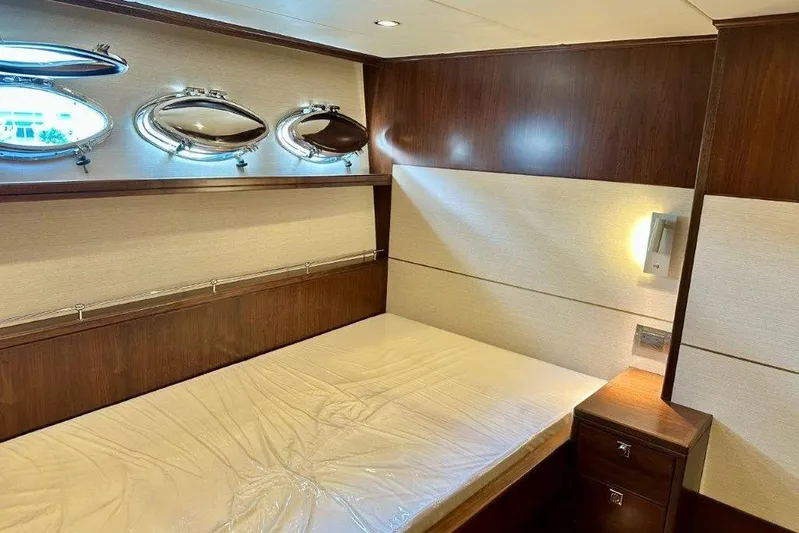  Yacht Photos Pics Luxurious Lanzarote 7702 yacht cabin interior with wood paneling and modern lighting, 2025 model.