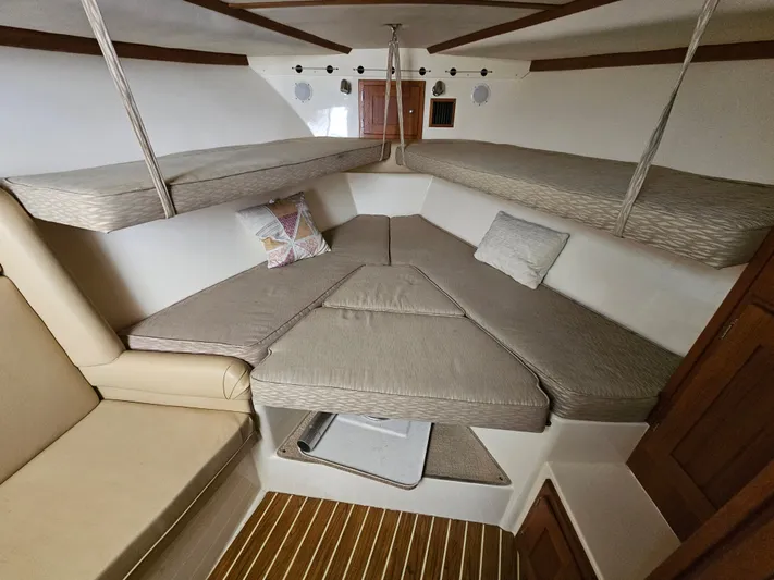  Yacht Photos Pics Interior of 2008 Albemarle 31 boat with cushioned seating and wooden accents.