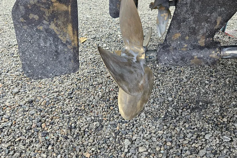  Yacht Photos Pics Propeller of a 2008 Albemarle 31 boat on gravel surface.