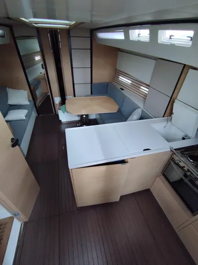Loic Yacht Photos Pics Modern interior of 2023 Italia Yachts Italia 14.98, featuring sleek kitchen and cozy seating area.