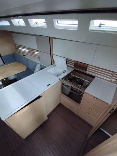 Loic Yacht Photos Pics Modern kitchen interior of 2023 Italia Yachts Italia 14.98 sailboat, featuring sleek design and appliances.
