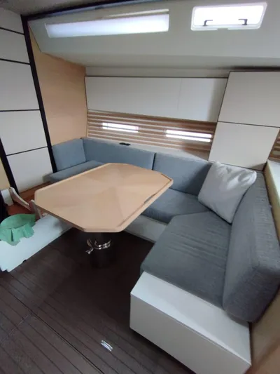 Loic Yacht Photos Pics Modern interior of 2023 Italia Yachts Italia 14.98 with sleek seating and table.