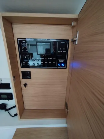 Loic Yacht Photos Pics Control panel inside 2023 Italia Yachts Italia 14.98, featuring modern wooden cabinetry.