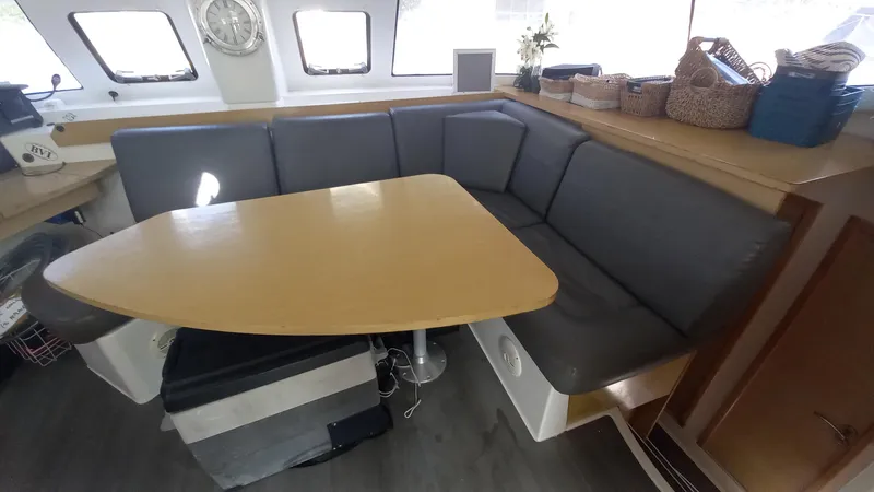 Double Trouble Yacht Photos Pics Interior of 2015 Fountaine Pajot Lipari 41 catamaran with cozy seating and wooden table.