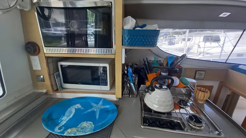 Double Trouble Yacht Photos Pics Galley kitchen in 2015 Fountaine Pajot Lipari 41 catamaran with appliances and nautical decor.