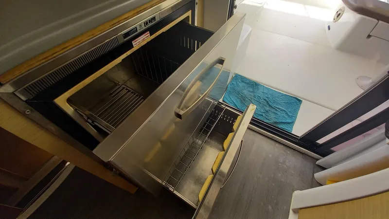 Double Trouble Yacht Photos Pics Open drawer in 2015 Fountaine Pajot Lipari 41 catamaran kitchen, showcasing storage space.