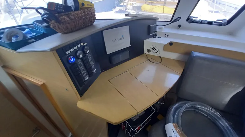 Double Trouble Yacht Photos Pics Navigation station inside 2015 Fountaine Pajot Lipari 41 catamaran, featuring control panel and seating.