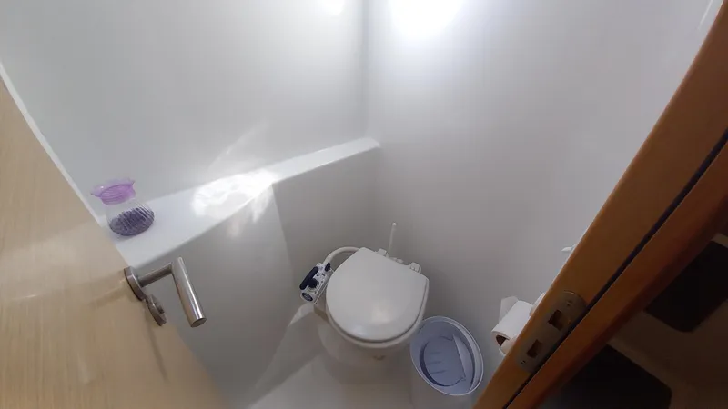 Double Trouble Yacht Photos Pics Compact bathroom in 2015 Fountaine Pajot Lipari 41 catamaran, featuring a modern toilet and minimalistic design.