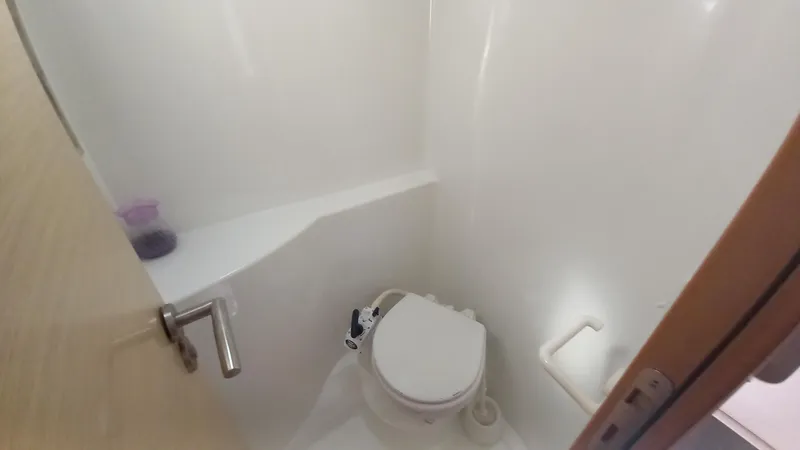 Double Trouble Yacht Photos Pics Compact bathroom in 2015 Fountaine Pajot Lipari 41 catamaran, featuring a modern marine toilet.