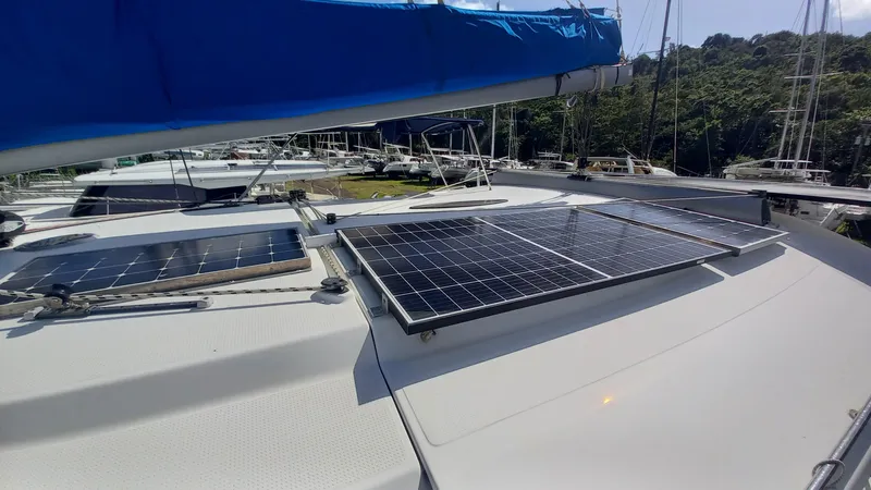 Double Trouble Yacht Photos Pics 2015 Fountaine Pajot Lipari 41 catamaran with solar panels on deck, docked in a marina.