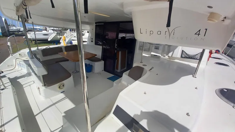Double Trouble Yacht Photos Pics 2015 Fountaine Pajot Lipari 41 catamaran interior with seating and dining area.