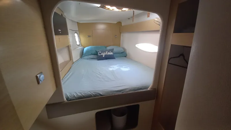 Double Trouble Yacht Photos Pics Cozy cabin interior of 2015 Fountaine Pajot Lipari 41 catamaran with bed and porthole.