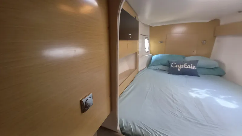 Double Trouble Yacht Photos Pics Cabin interior of 2015 Fountaine Pajot Lipari 41 catamaran with bed and "Captain" pillow.
