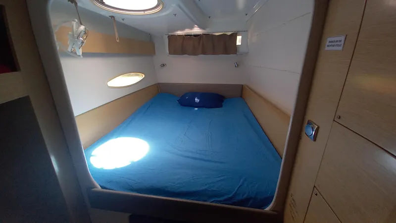 Double Trouble Yacht Photos Pics Cozy cabin interior of 2015 Fountaine Pajot Lipari 41 catamaran with blue bedding.
